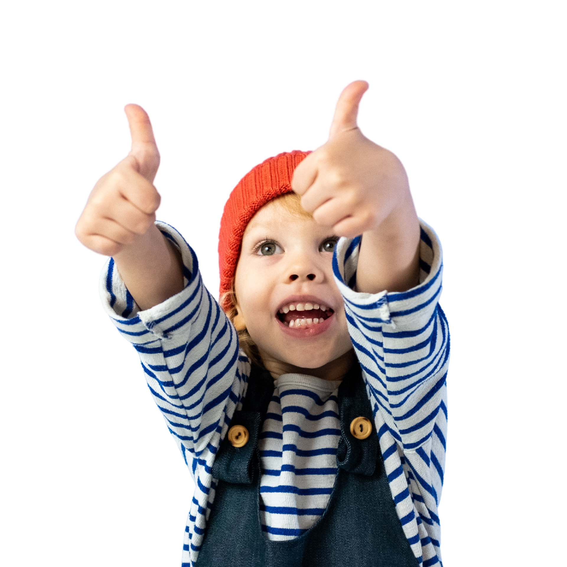 A smiling young boy raises his thumbs. He has a red hat on and wears a sailor t-shirt and an overall.  